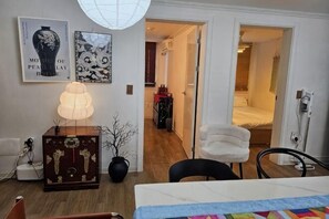 A room with a bed, a chair, a desk, a lamp, and a dresser. There is a door leading to another room. - 8 minutes away from Chungmuro Station, hill location,Breakfast for more than five nights (Seoul)
