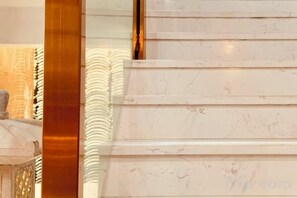 A marble staircase with a polished finish and a golden accent on the left. - Youngsun Hotel (Sihanoukville)