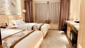 A hotel room with two beds, a desk, and a window with curtains. - Youngsun Hotel (Sihanoukville)