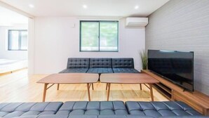 A modern living room with a sofa set, a TV, and a wooden coffee table. - 10min on foot from Hirai Station. 11min by train to Akihabara Station. (Tokyo)