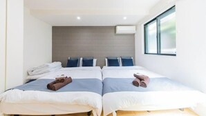 A modern hotel room with two beds, a wooden headboard, and a large window. - 10min on foot from Hirai Station. 11min by train to Akihabara Station. (Tokyo)