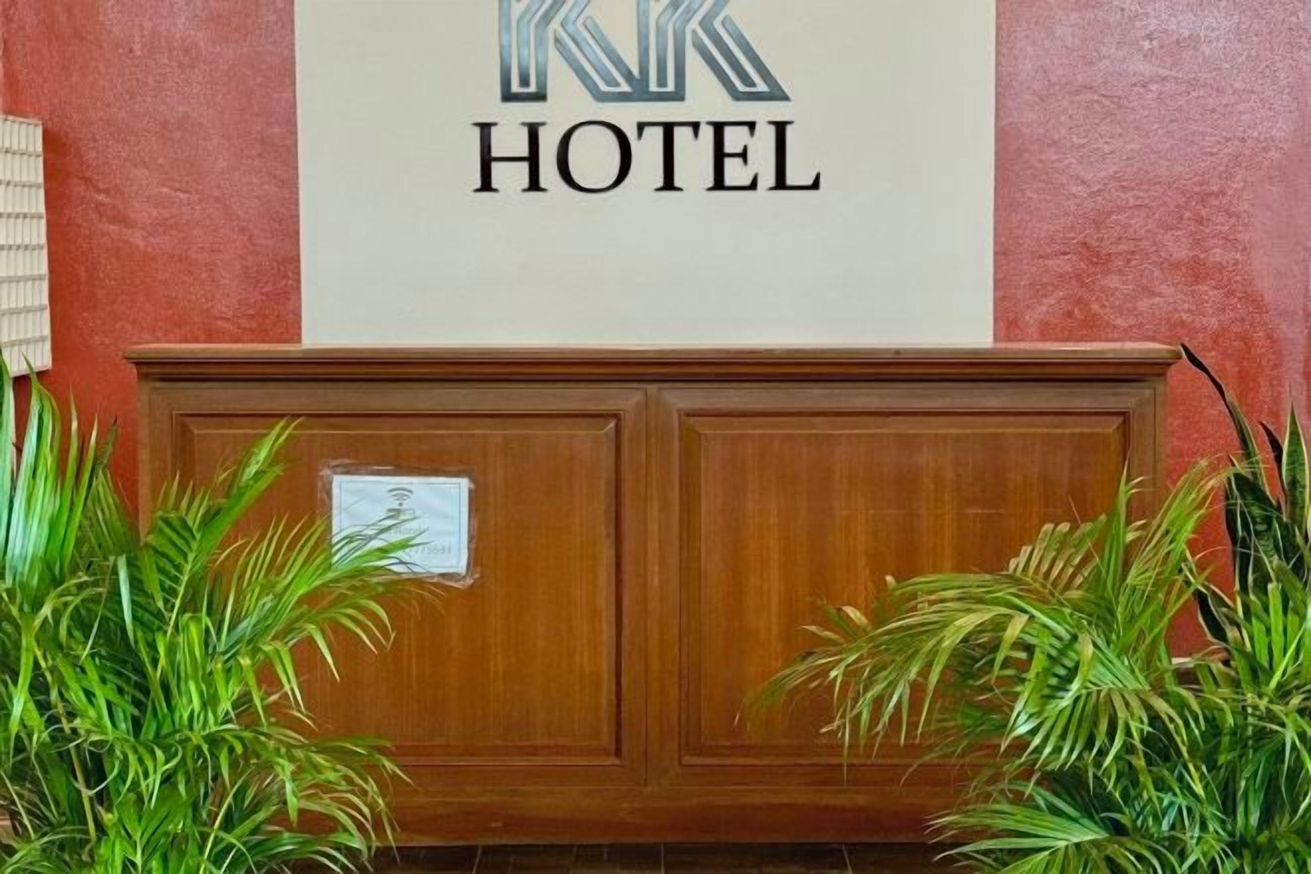 A reception desk with a sign above it that reads 'RK HOTEL'.