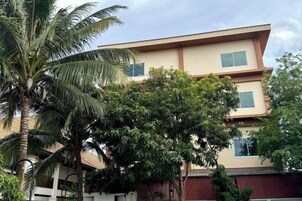 A two-story building with a flat roof and a beige facade.