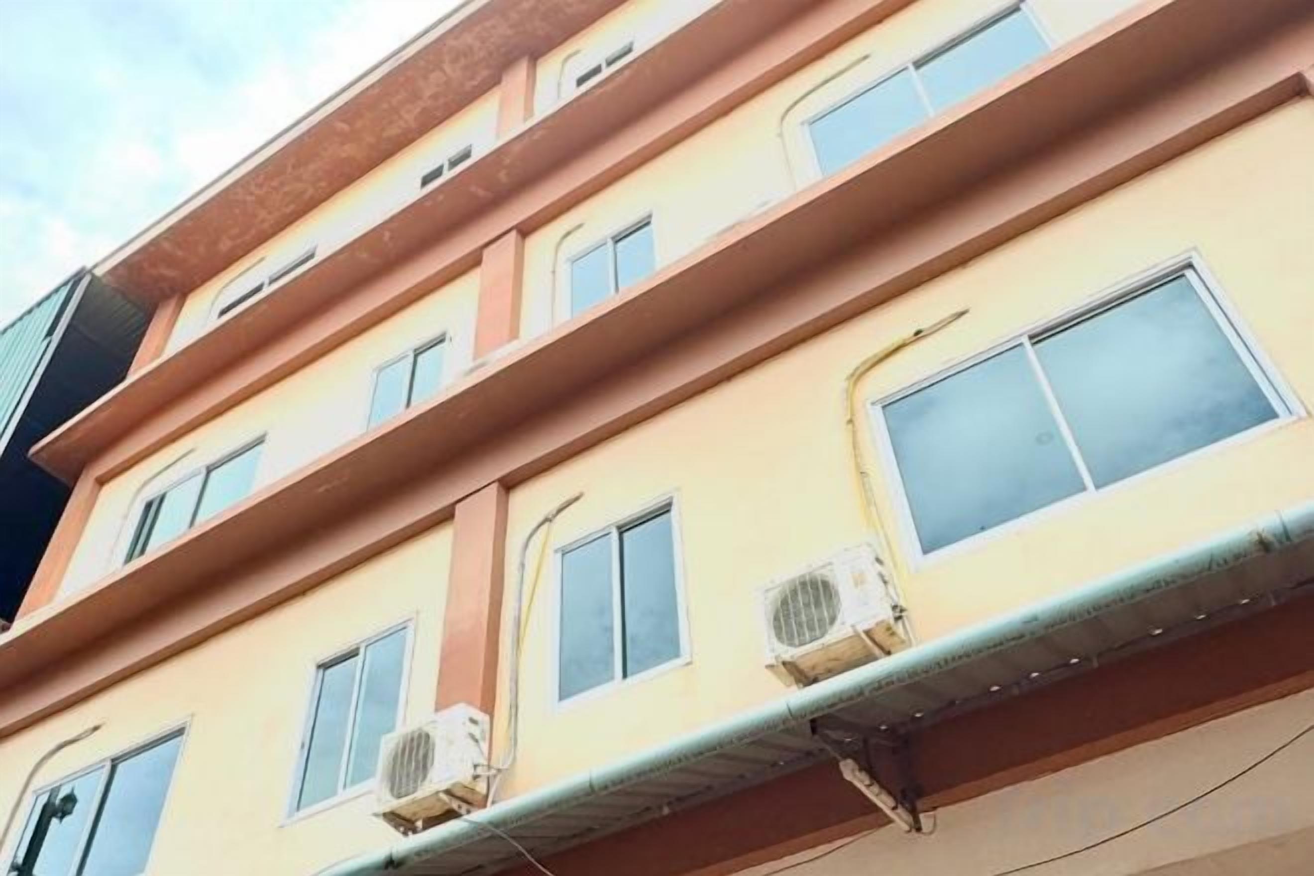 A multi-story building with air conditioning units on the exterior.