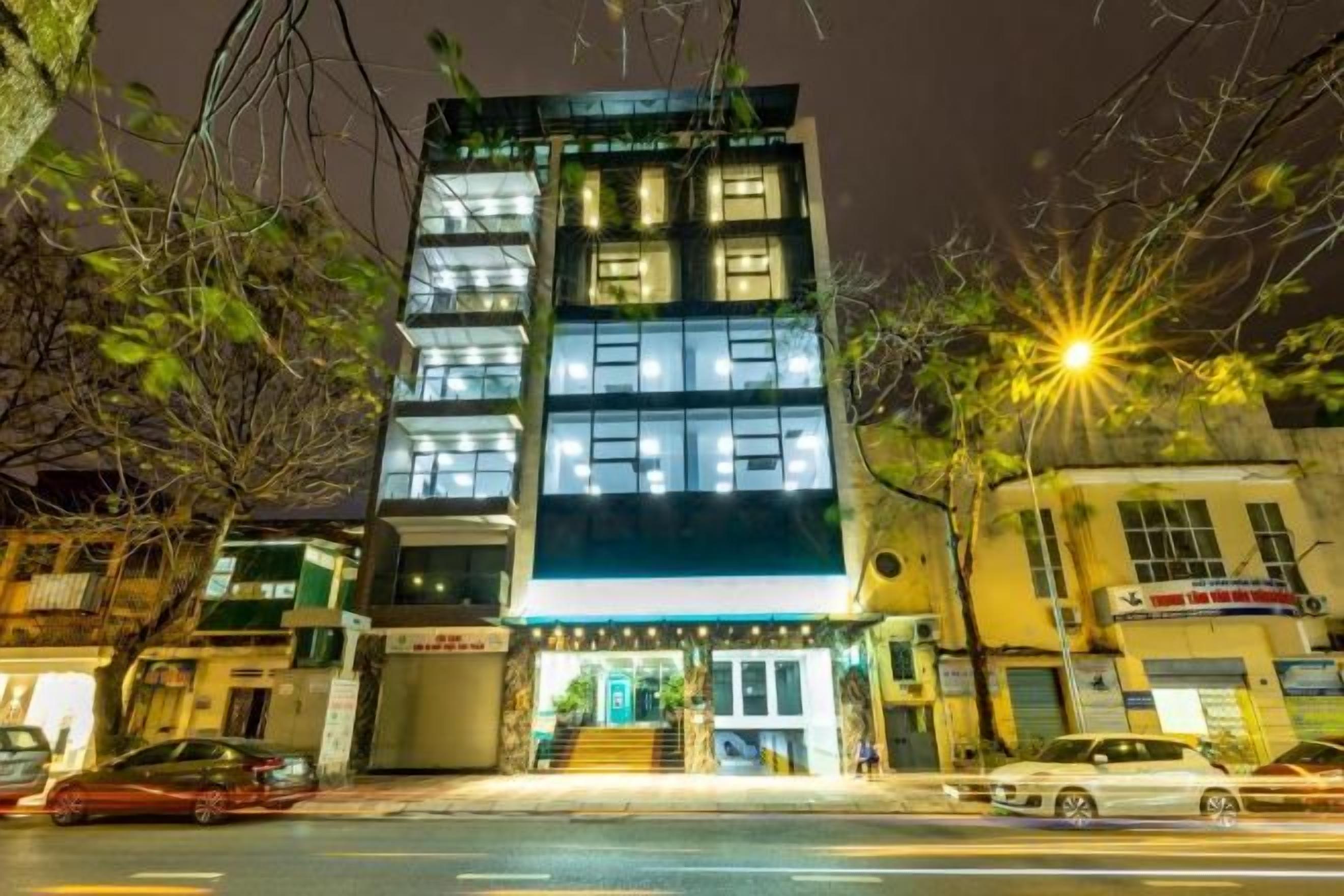 A multi-story building with a ground-level entrance and a staircase leading to the second floor.