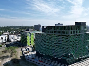 A modern building with a unique geometric facade, surrounded by other buildings and a clear sky. - 56 Hotel Block B (Kuching)