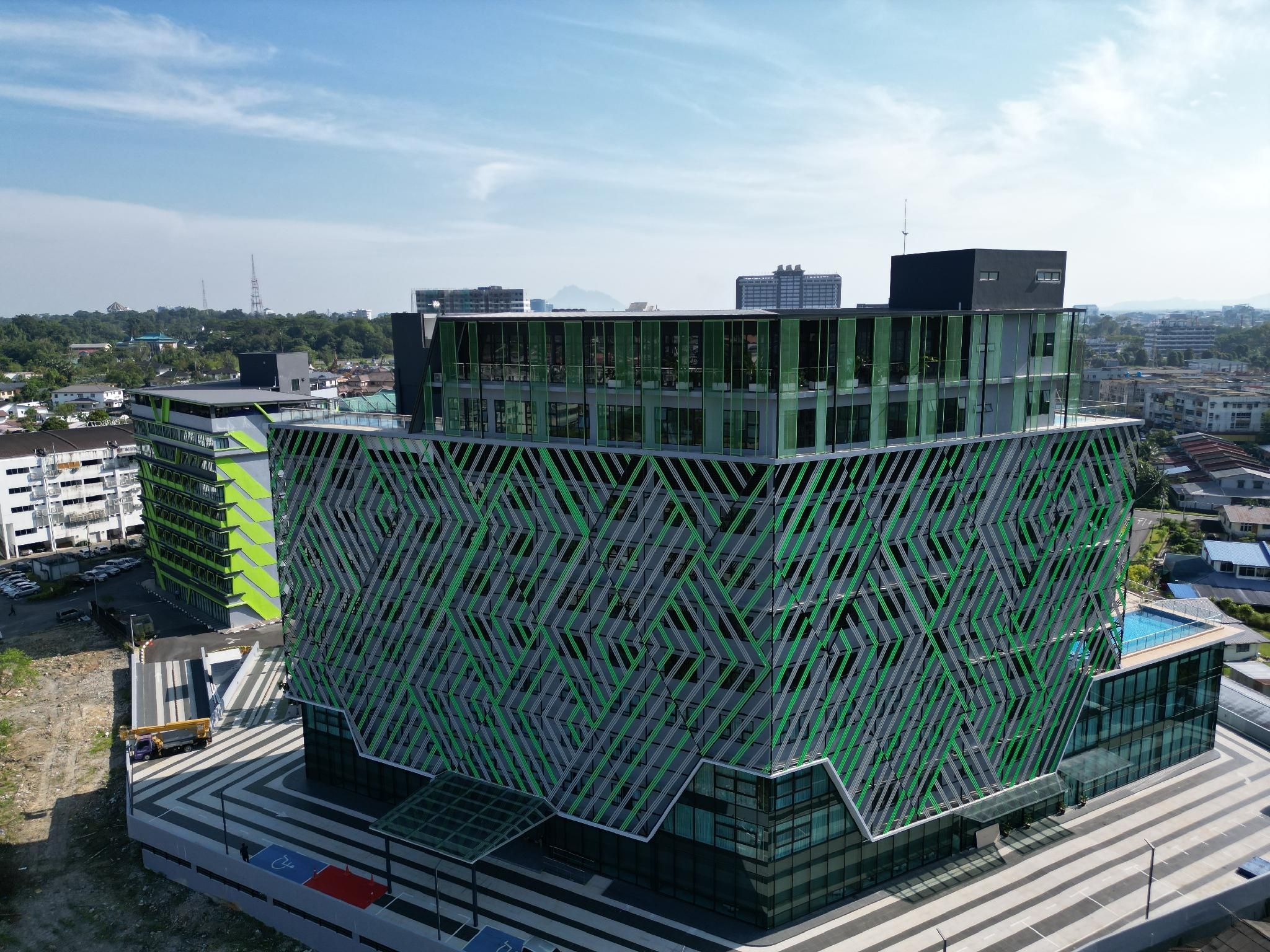 A modern building with a unique geometric facade, multiple floors, and a flat roof.