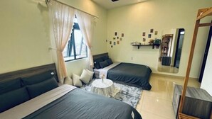 A room with two beds, a round table, a mirror, and a window with curtains. - Homieow inn (Dalat)