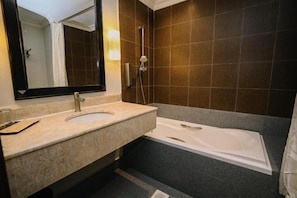 A bathroom with a sink, mirror, and bathtub. - Kingston Hotel 9 @ Jonker Street Malacca (Melaka)