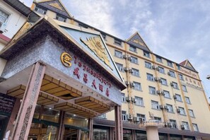 A hotel with a prominent entrance, multiple floors, and a traditional architectural style. - SHENGCHANG HOTEL (Muang Xai)