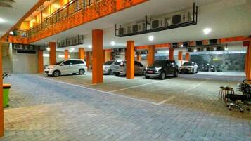 A multi-level parking garage with vehicles parked on both levels.