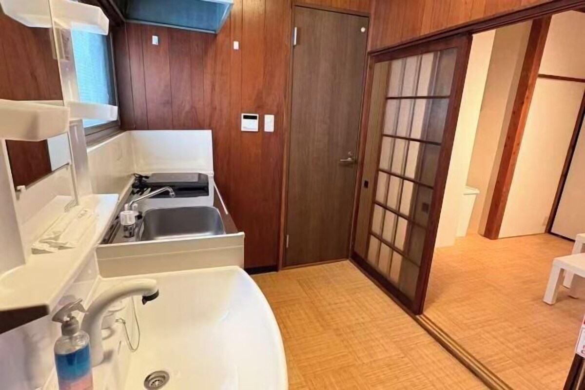 A bathroom with a sink, mirror, and towel rack.