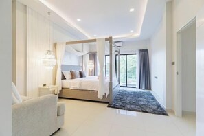 A modern bedroom with a four-poster bed, a bedside table, a chair, and a large window. - Pattaya detached four-bedroom five-bed room pool villa (Pattaya)