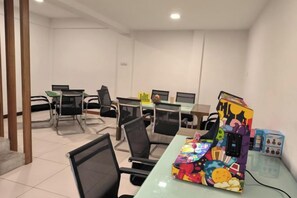 A conference room with tables and chairs, a colorful box on one table, and a whiteboard in the background. - Deco Home Mesilau Golf Bungalow @ Kundasang (Kundasang)