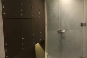 A set of dark-colored lockers with a metallic door in the background. - Andromeda Condominium Seaview Amazing Room (Pattaya)