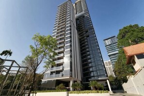 A high-rise building with multiple floors, balconies, and a modern architectural design. - Andromeda Condominium Seaview Amazing Room (Pattaya)