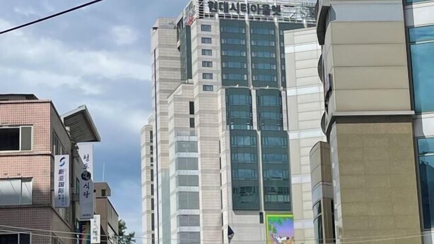 A multi-story building with a modern architectural design, featuring a prominent sign at the top. - HaiLun Officetel (Seoul)