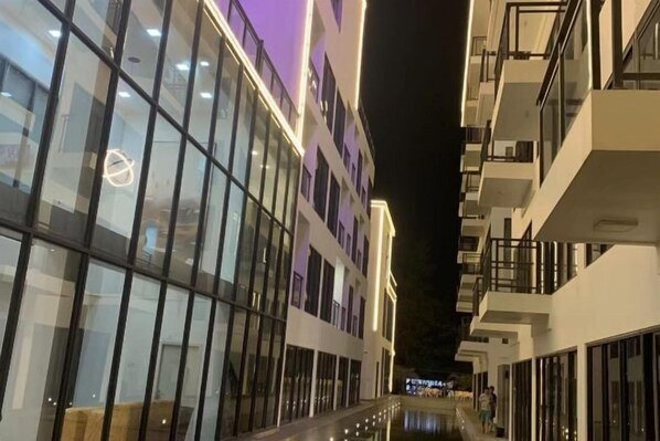 A modern building with large glass windows and balconies.