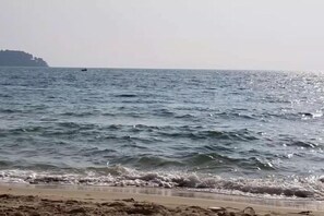 A beach with waves and a distant landmass. - 520 Seaview Hotel (Sihanoukville)