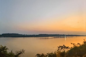 Une étendue d'eau calme, avec une rive lointaine et un pont.