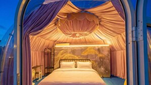 A luxurious, circular room with a bed centered in the middle, draped curtains, and a unique ceiling design. - Turtle Garden Resort @ Semporna (Semporna)