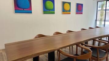 A conference room with a long wooden table and six chairs.