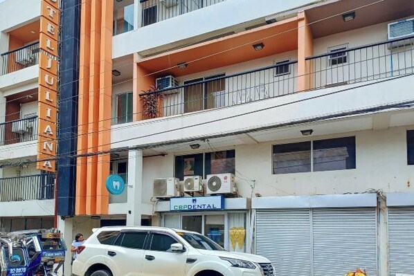 A multi-story building with a sign for 'Hotel Templiana' on the facade. - Hotel Juliana by RedDoorz (Tuguegarao)