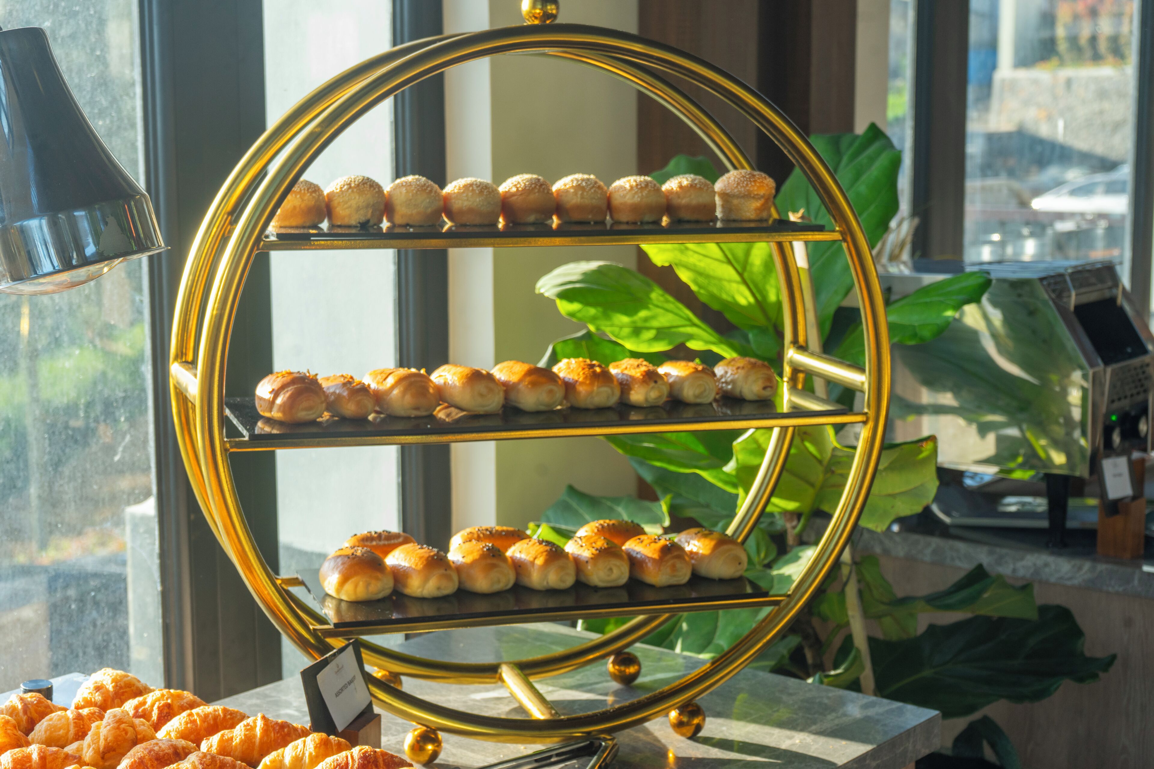 A three-tiered display stand with pastries.