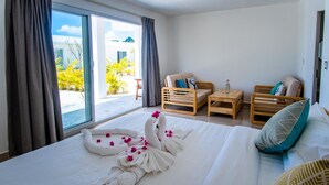 A hotel room with a bed, two wooden chairs, a small table, and a view of the outdoors. - You Me Resort (Koh Rong)