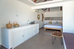 A bedroom with a bed, bedside table, and a small stool. - You Me Resort (Koh Rong)