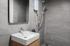 A bathroom with a white sink, a mirror, and a shower unit. - Pavillion Bukit Jalil 【Walk 2 mins】Stylish Lily Studio 2-4 Pax (Kuala Lumpur)