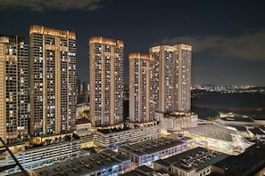 A high-rise residential building complex at night with illuminated windows and a view of the cityscape. - Pavillion Bukit Jalil 【Walk 2 mins】Stylish Lily Studio 2-4 Pax (Kuala Lumpur)