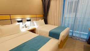A hotel room with two beds, a nightstand with a lamp, and a view through sheer curtains. - Ark House (Phnom Penh)