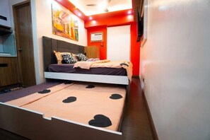 A bedroom with a bed, a desk, and a chair. - Near Manila Airport. Lovely "HOTEL STYLE" Studio Condo, With Kitchenette + Swimming Pool, 7A (Paranaque)