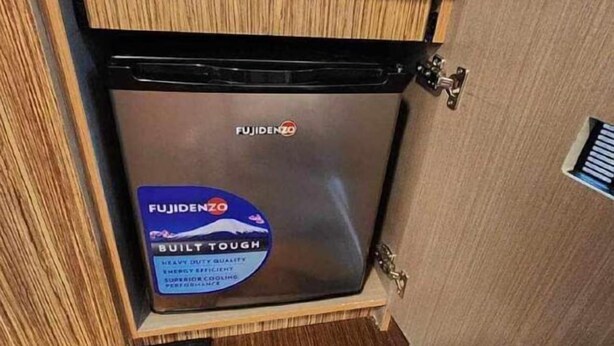 A compact, built-tough Fujidenzo refrigerator in a wooden cabinet. - Near Manila Airport. Lovely "HOTEL STYLE" Studio Condo, With Kitchenette + Swimming Pool, 7A (Paranaque)