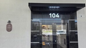 A building entrance with a large number '104' above the door. - Busan Ocean Stay (Busan)