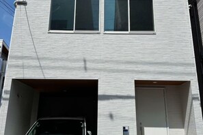 A building with a garage entrance and a door. - qinglang (Osaka)