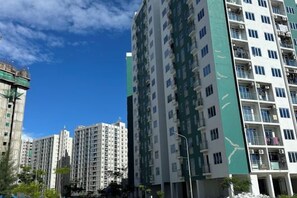 A high-rise residential building with multiple balconies and a clear sky. - Beach Stay by Wahuj Maldives (Malé)