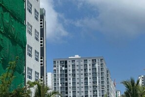 A multi-story building with a modern architectural design, featuring a grid-like facade and numerous windows. - Beach Stay by Wahuj Maldives (Malé)
