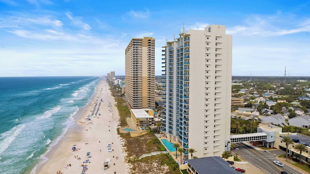 A beachfront hotel with multiple high-rise buildings, a sandy beach, and a swimming pool. - Beachfront Stay w/ Resort Amenities & Gulf Views Sterling Breezing #506 (Panama City Beach)