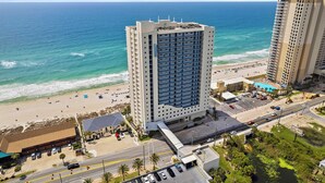 A high-rise hotel with a beach view, multiple floors, and a parking area. - Sterling Breeze #604 Beachfront Condo w/ Balcony, Pool, Hot Tub & Pier Park (Panama City Beach)