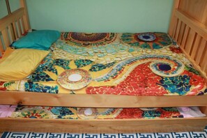 A bed with a colorful, patterned bedspread and two pillows. - Happy Hostel (Ulaanbaatar)