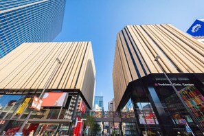 A modern building with a glass facade and a sign for 'Toshiba Civic Center.' - Ikebukuro Central Hotel (Tokyo)