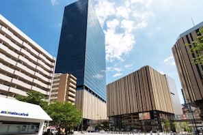 A cityscape with modern buildings, including a tall skyscraper and a building with vertical lines. - Ikebukuro Central Hotel (Tokyo)