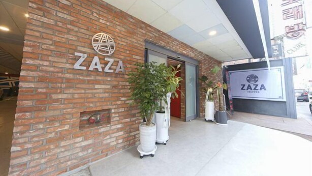 A brick facade with the ZAZA HOTEL sign, potted plants, and a clear entrance. - ZAZA Hotel (Bucheon-si)