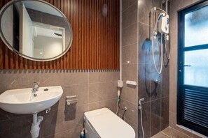 A bathroom with a sink, mirror, shower, and toilet. - MAXIM BY FEEL HOME (Kuala Lumpur)