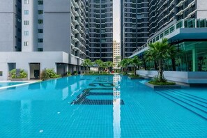 A swimming pool surrounded by modern high-rise buildings. - MAXIM BY FEEL HOME (Kuala Lumpur)