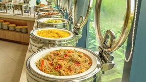 A buffet with various dishes in metal containers, some with lids open. - The Arenam Cam Ranh Nha Trang Resort (Cam Ranh)