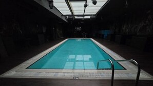 An indoor swimming pool with a tiled floor, metal handrails, and a skylight above. - Gulf Inn Hotel Al Nasr, Bur Dubai (Dubai)