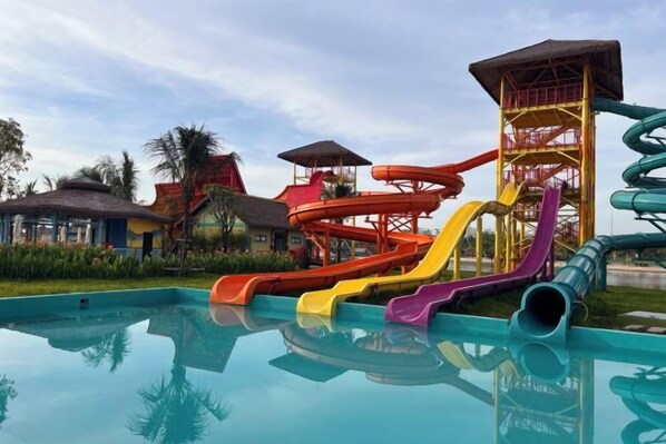 A water park with multiple slides and a pool.